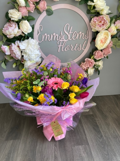Rainbow Bouquet - Seasonal Flowers in mix of colours arranged as a hand tied and presented in water.