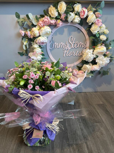 Blooms Delight - Aqua Packed bouquet in seasonal flowers in pink, white and purple flowers.