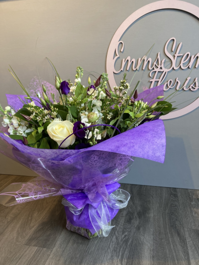 Sweetness - A beautiful Bouquet full of Purple and White Flowers with foliage and finished in a stunning gift wrap in water.