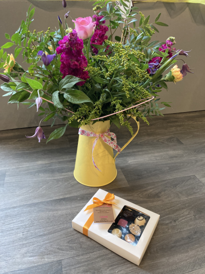 Jug Gift & Chocolates - A lovely scented hand tied bouquet presented in a yellow jug and also includes a box of luxury chocolates.