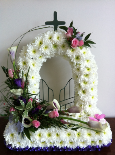 Gates of Heaven - Beautifully made in White Chrysanthemums with a lovely spray of Flowers in Roses and Calla Lilies.