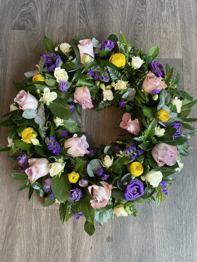 Wreath - Wreath in Mauve, Purple, Yellow & White seasonal flowers including memory lane roses.
Standard- 12"
Medium- 14"
Large-16"
Extra Large- 18"