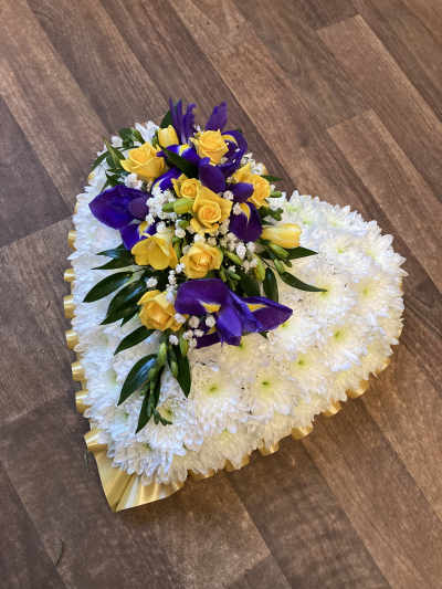 White Massed Heart - White Massed Heart with yellow ribbon & blue& yellow flower spray
Standard- 12"
Medium-15"
Large-18"