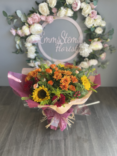 Autumn Glow - Lovely seasonal autumnal colours of flowers and foliage arranged in a hand tied bouquet and presented in water.