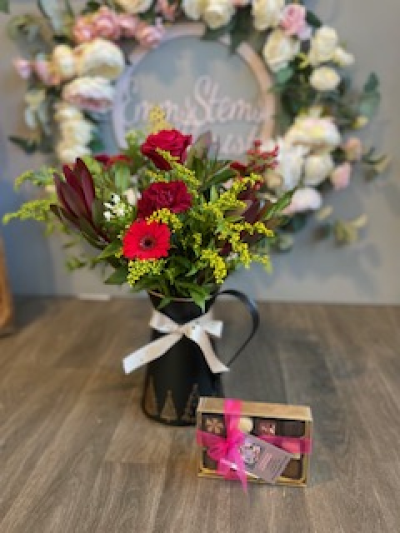 Christmas Jug and Belgium Chocolates - Beautiful seasonal Flowers arranged in a lovely Festive Zinc Jug. Including a lovely box of Belgium Chocolates.